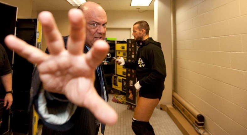 WWE backstage moment showing creative tension between management and a wrestler before a match